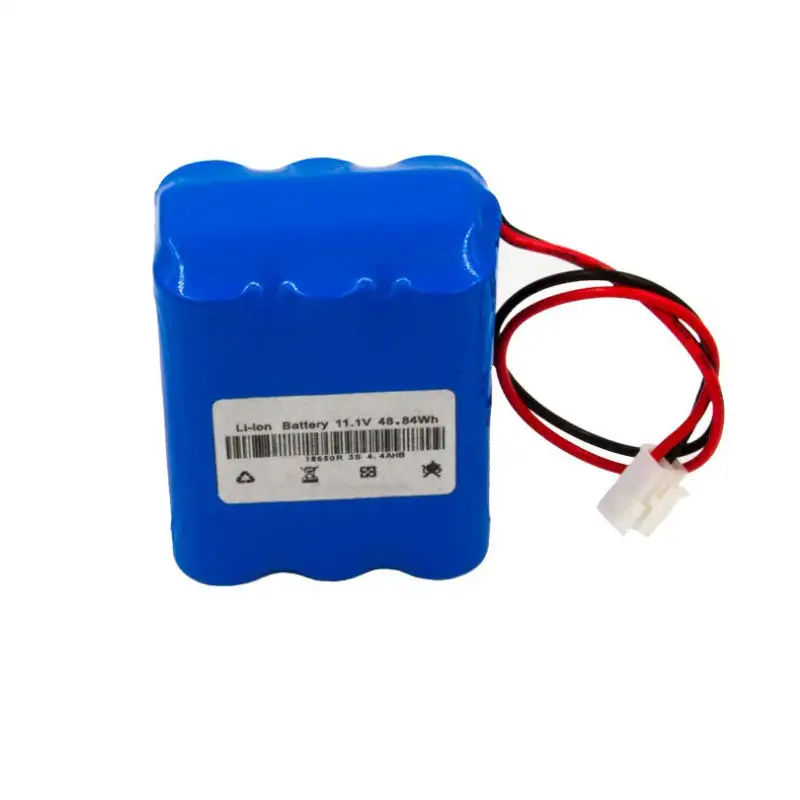 Blue rechargeable lithium battery connected to outdoor solar spotlight